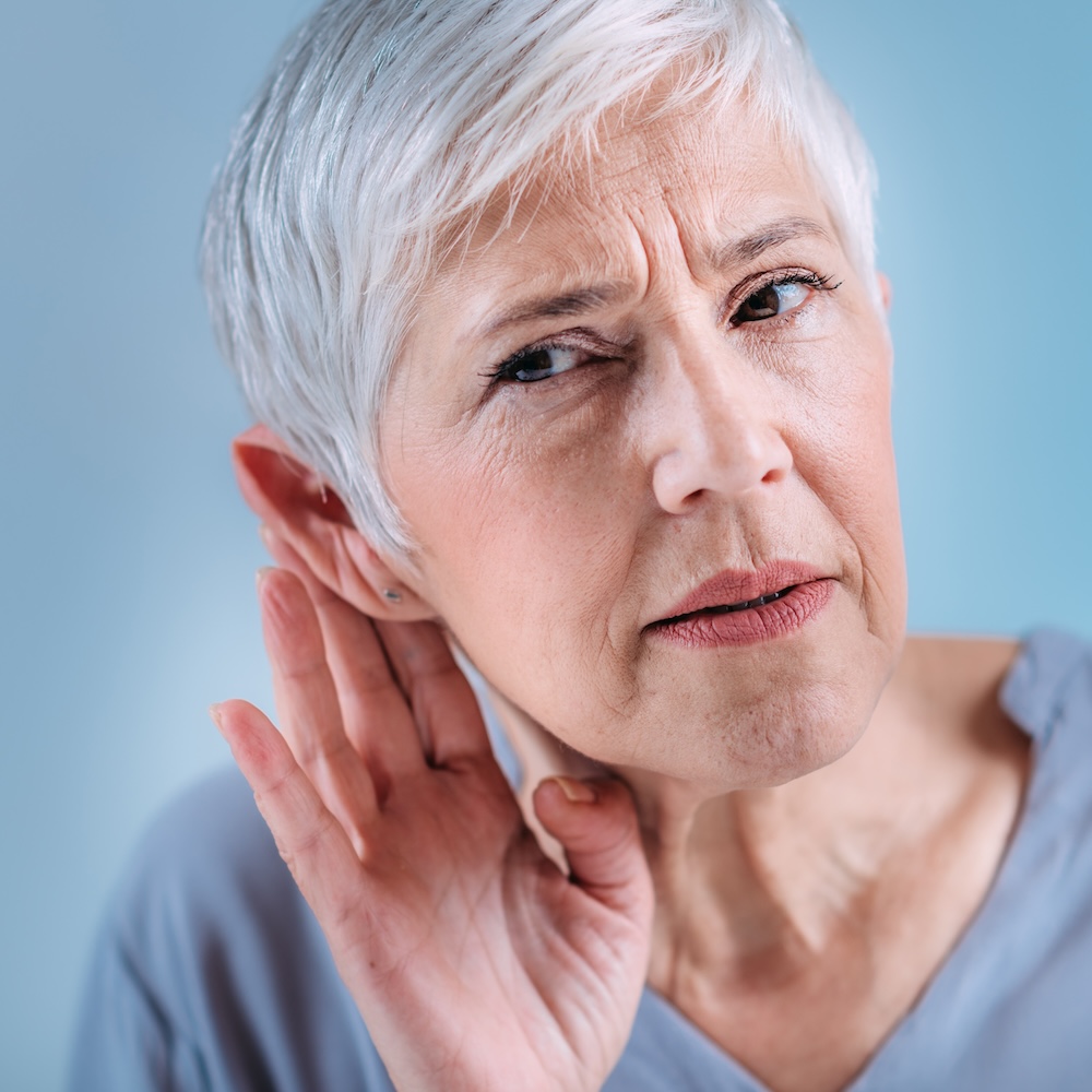 Hearing loss. Senior woman with symptoms of hearing loss. Ear Wax Removal.